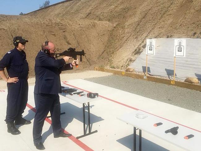 NSW Police Minister David Elliott firing a Heckler and Koch UMG 40 and a Glock pistol at John Morony Correctional Centre in November 2018. These photos were posted on David Elliott's Facebook page on September 10, 2018.