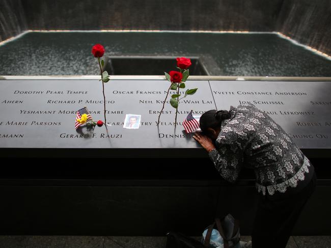 A woman grieves at her husband's memorial at South Tower Memorial Pool before memorial observances for the September 11. Picture: Chang W. Lee