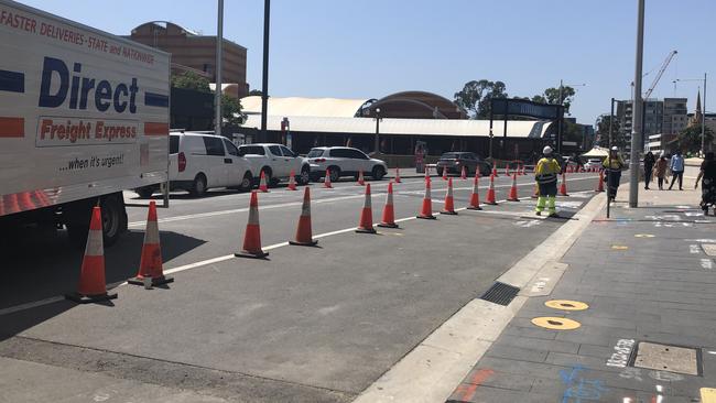 Workers get ready to block traffic on Church St between Macquarie and Market streets.