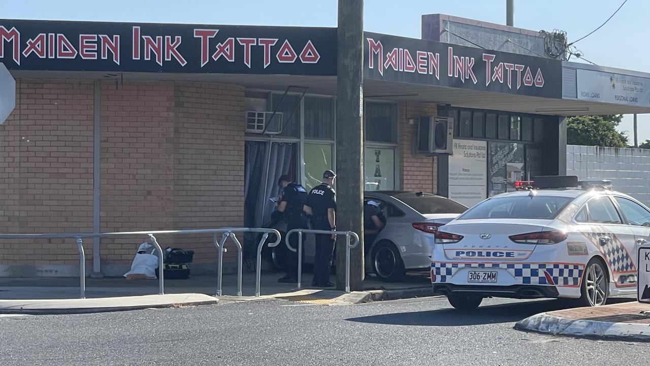 Car smashes into tattoo shop, shatters windows