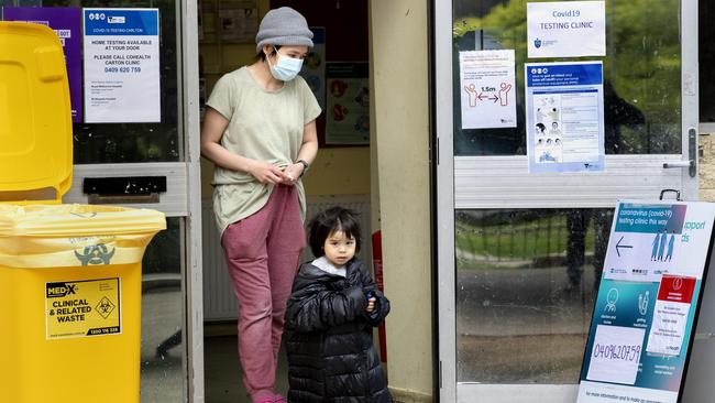 A woman and her daughter leave a COVID testing site on Lyon St in Carlton, Melbourne. Picture: NCA NewsWire / David Geraghty