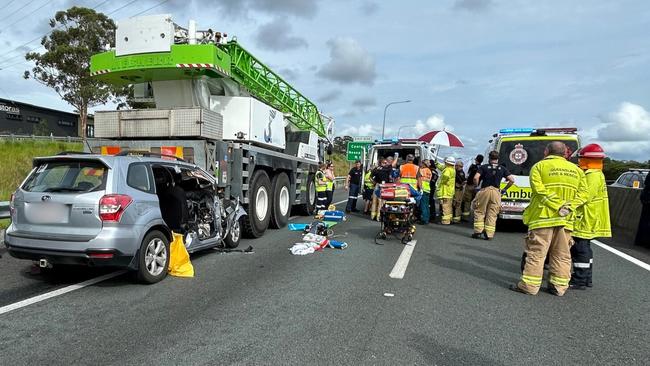 A teenager is fighting for life after his car ran into the back of a crane truck on the Bruce Highway near Cooroy.