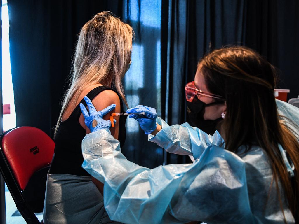A health care worker administers a Covid-19 vaccine during a vaccination event hosted by Miami Heat at FTX Arena in Miami.