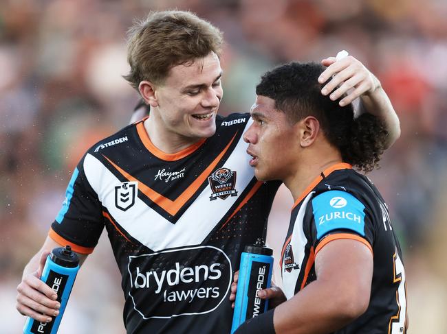 SYDNEY, AUSTRALIA - JUNE 23: Luke Laulilii of the Tigers (R) celebrates with Lachlan Galvin of the Tigers (L) after scoring a try during the round 16 NRL match between Wests Tigers and Canberra Raiders at Campbelltown Stadium, on June 23, 2024, in Sydney, Australia. (Photo by Matt King/Getty Images)