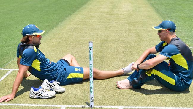 Joe Burns (left) and David Warner (right) sit together on the pitch at the Gabba in Brisbane on Wednesday. Picture: AAP Image/Darren England