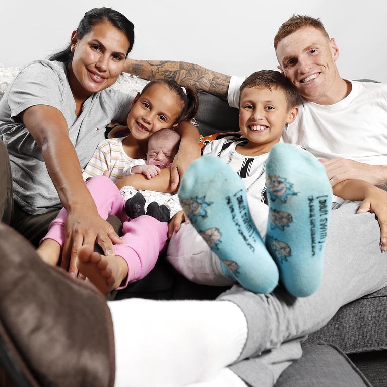 Brisbane Lions star Mitch Robinson and Emma MacNeill with children Charli, 6, Chance, 8, and Maali Robinson, two weeks, in their trackpants for Tracky Dack Day. Picture: Josh Woning