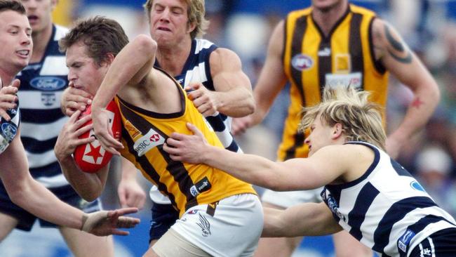 Gary Ablett tackles Luke Hodge very early in their AFL careers in 2004.