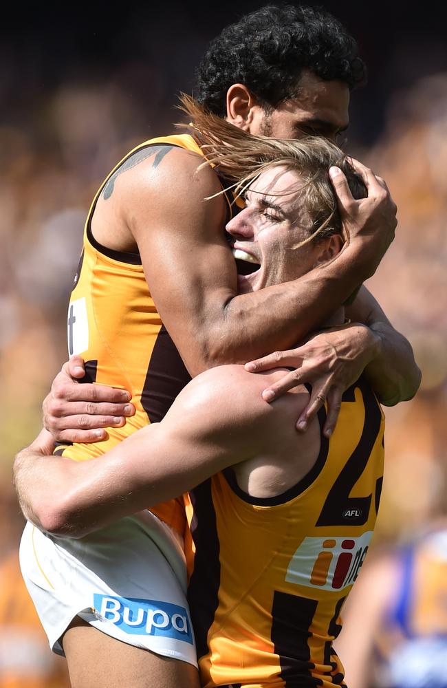 Cyril Rioli and Ryan Schoenmakers celebrate a Hawthorn goal.