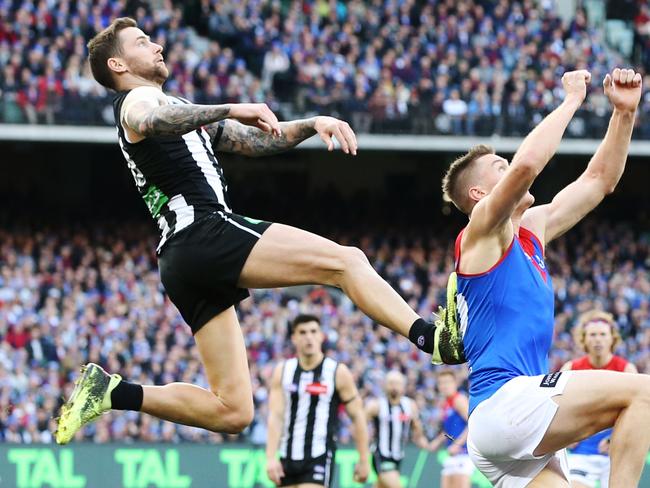 MELBOURNE, AUSTRALIA - JUNE 10: Jeremy Howe of the Magpies leaps into Tom McDonald of the Demons for an attempted mark but was penalised during the AFL Round 12 match between Collingwood v Melbourne at Melbourne Cricket Ground on June 10, 2019 in Melbourne, Australia. (Photo by Michael Dodge/AFL Photos/Getty Images)