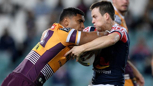 Broncos Tevita Pangai Jr is tackled by Roosters’ Luke Keary. Picture: AAP