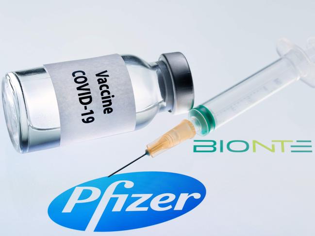 (FILES) This file illustration picture taken on November 24, 2020 shows a bottle reading "Vaccine COVID-19" and a syringe next to the Pfizer and BioNtech logos. - Mexico will receive the first vaccines against COVID-19, developed by Pfizer and BioNTech, on December 23, 2020, Mexican Foreign Minister Marcelo Ebrard announced on December 22. (Photo by JOEL SAGET / AFP)