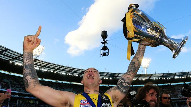 Brownlow Medallist Dustin Martin with the 2017 premiership cup and Norm Smith Medal after his all-conquering season. Picture: Mark Stewart