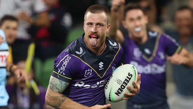 MELBOURNE, AUSTRALIA - APRIL 16: Cameron Munster of the Storm celebrates on his way to scoring a try during the round six NRL match between the Melbourne Storm and the Cronulla Sharks at AAMI Park, on April 16, 2022, in Melbourne, Australia. (Photo by Robert Cianflone/Getty Images)