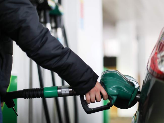 (FILES) In this file photo taken on November 20, 2017 A motorist uses a pump as they re-fuel their car with unleaded petrol at a filling station in central London. - British inflation hit a near four-year low in April as oil prices crashed, official data showed Wednesday, May 20, with the rate set to slide further as the coronavirus slashes prices generally. (Photo by Daniel LEAL-OLIVAS / AFP)