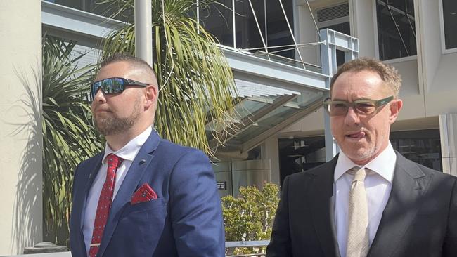 Ex-police officer Rowan Leslie Larkin (left) leaving the Southport courthouse with lawyer Dan Rawlings. Picture: Jessica Paul