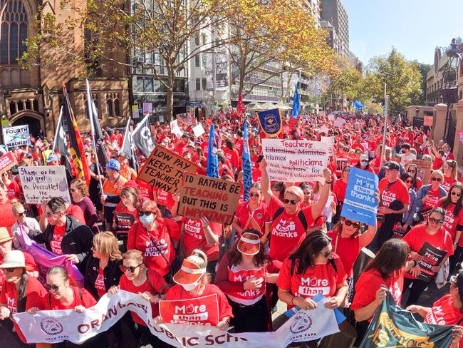 SYDNEY, AUSTRALIA - MAY 04: School teachers march along Macquarie St towards NSW Parliament on May 04, 2022 in Sydney, Australia. Tens of thousands of teachers across New South Wales are taking part in a 24-hour strike to protest pay and staff shortages. Wage increase negotiations between the union and the state government have been postponed until after June's state budget.  (Photo by Jenny Evans/Getty Images)