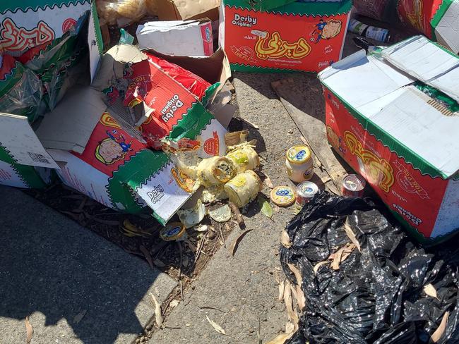 Smashed jars of hummus were among copious piles of expired food dumped illegally at Villawood. Picture: Supplied