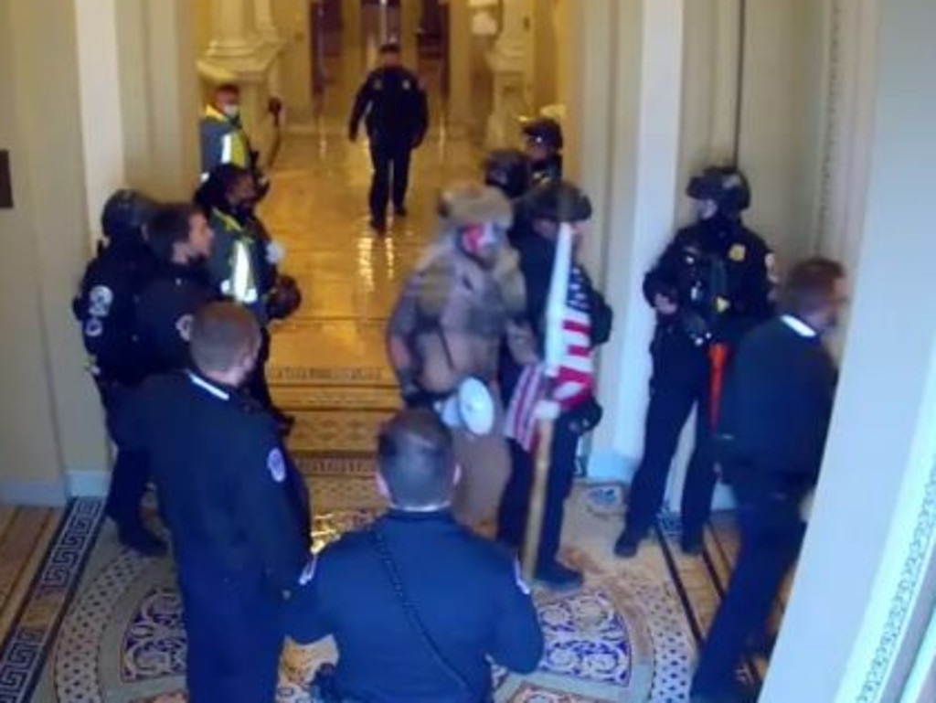 January Footage Shows Capitol Cops Escorting QAnon Shaman To Senate Floor The Courier Mail