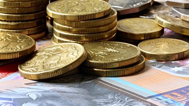 Stacks of Australian coins on Australian notes. Money generic