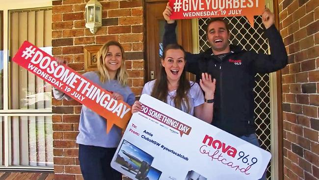 Nova 969 presents flood victim Amie with a cheque to replace her damaged furniture.