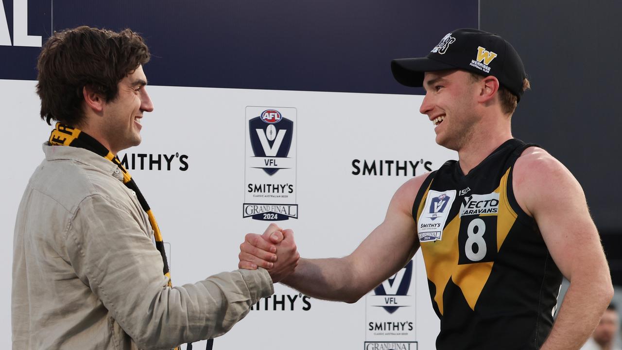 Shaun Mannagh presents the Norm Goss Medal to Jack Henderson. Picture: Rob Lawson/AFL Photos via Getty Images