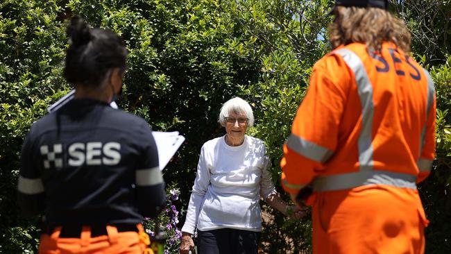 92 year old Alma Fair spoke with SES personnel about the evacuation order as she pruned her garden. Picture: Gary Ramage