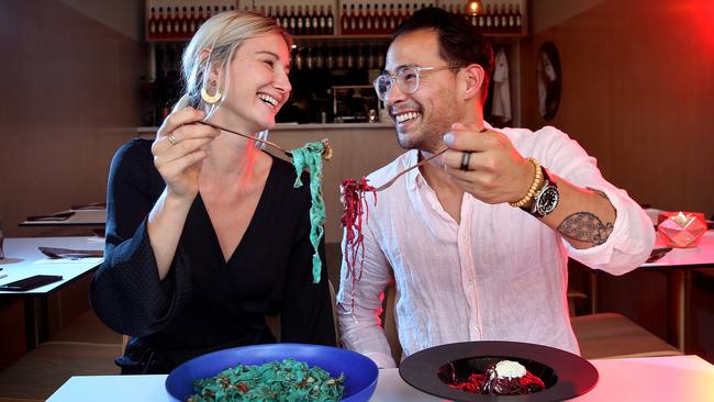 Mel Brass and Conrad Cheng tucking into mult-coloured vegan pasta at Mark + Vinny's Spaghetti and Spritz Bar in Surry Hills. Picture: Richard Dobson