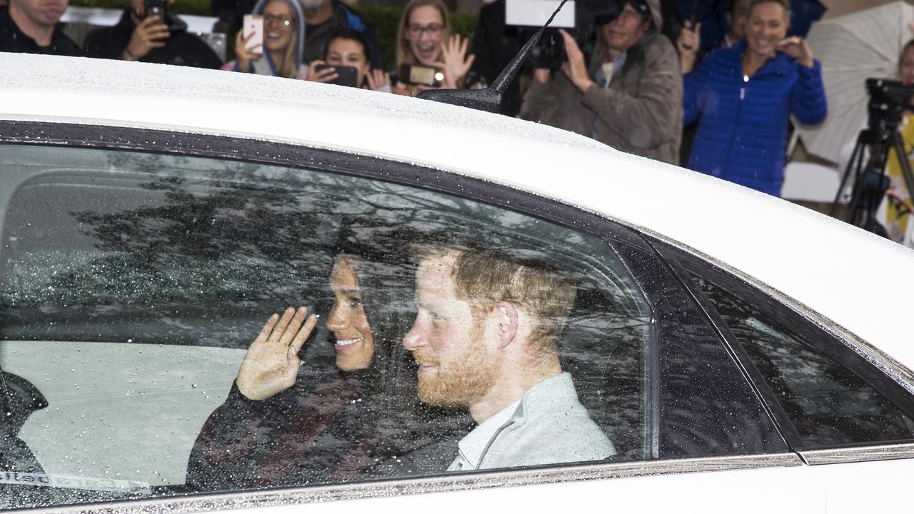 Meghan waved as their car drove through the gates. Picture: Dylan Robinson