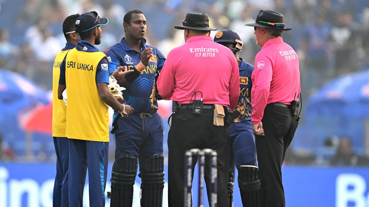 Sri Lanka's Angelo Mathews (3L) speaks with the umpires after he was timed out during the 2023 ICC Men's Cricket World Cup one-day international (ODI) match between Bangladesh and Sri Lanka at the Arun Jaitley Stadium in New Delhi on November 6, 2023. (Photo by Sajjad HUSSAIN / AFP)