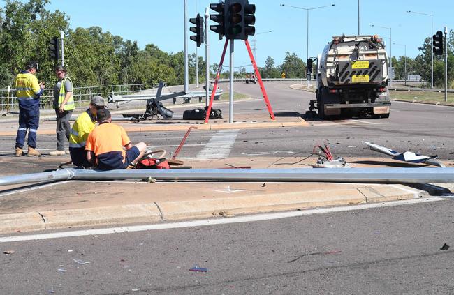 Workers work on fixing damage on the scene at the intersection. Picture: Katrina Bridgeford