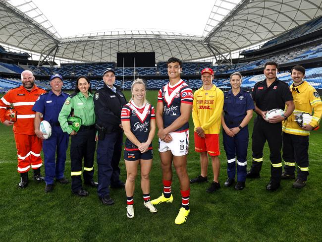 Emergency services crew with Roosters players Tarryn Aiken and Joseph-Aukuso Suaalii. Picture: Phil Hillyard