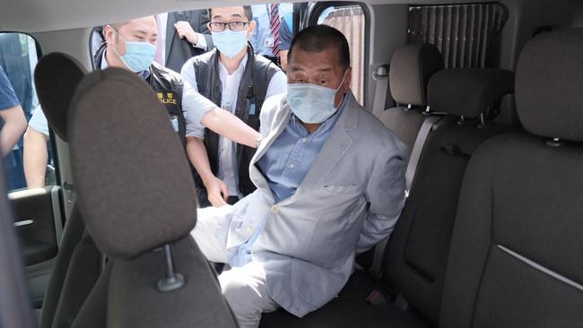 Jimmy Lai is taken from his residence by law enforcement officials in Hong Kong on Monday. Picture: Bloomberg