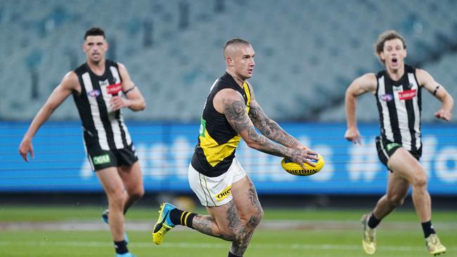 Dustin Martin of the Tigers runs with the ball during the Round 2 AFL Match between the Collingwood Magpies and Richmond Tigers at the Melbourne Cricket Ground in Melbourne, Thursday, June 11, 2020. (AAP Image/Michael Dodge) NO ARCHIVING, EDITORIAL USE ONLY