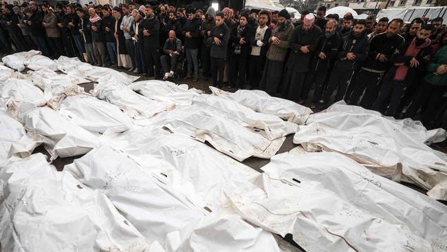 Palestinians mourning their relatives at a mass funeral in the southern Gaza strip in December. Picture: AFP