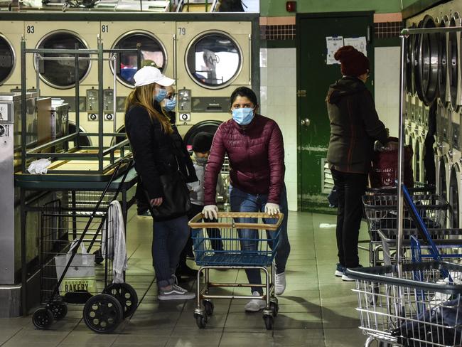 New Yorkers do their laundry at a Brooklyn laundromat. Picture: Getty Images/AFP