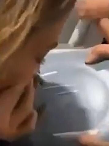 Nadia Bartel snorting white powder in a video.