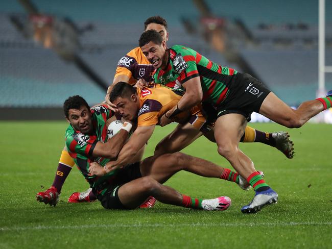 Brisbane's Kotoni Staggs is tackled into touch. Picture: Brett Costello