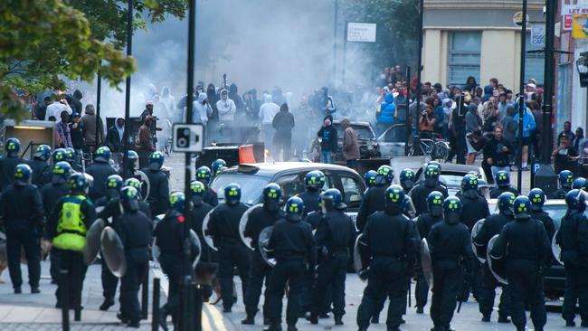 Riot police face a mob in London during the 2011 riots.