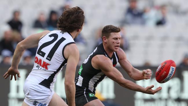 Port’s Jared Polec chases Collingwood’s Taylor Adams yesterday. Picture: AAP Image/David Crosling