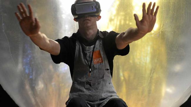 PLAYING WITH REALITY: Rockhampton Art Gallery volunteer Jarred Kennedy experiences the virtual reality headset in front of Andrew Styan's Life Support System 2016 installation. Picture: Jann Houley