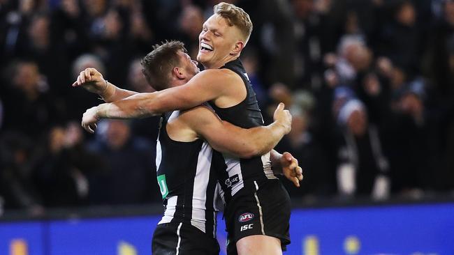 Adam Treloar celebrates on the siren with Taylor Adams. Picture: Phil Hillyard