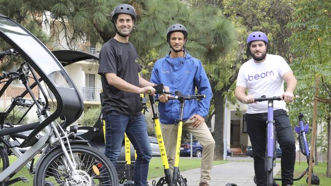 Tom Cooper (left) with a RIDE scooter on the day RIDE and Beam started a trial in Adelaide. Picture: Dean Martin