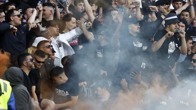 Fans set off flares as things descend into chaos at the Melbourne derby. Picture: Darrian Traynor/Getty Images