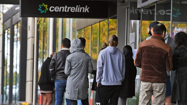 People queue up outside a Centrelink office in Melbourn. Picture: AFP.