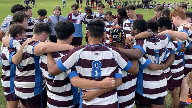 Beni Allen, wearing No. 8, in the John Paul College huddle.