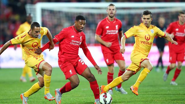 ADELAIDE, AUSTRALIA - JULY 20: Jordon Ibe of Liverpool is challenged by Tarek Elrich of United during the international friendly match between Adelaide United and Liverpool FC at Adelaide Oval on July 20, 2015 in Adelaide, Australia. (Photo by Matt King/Getty Images)