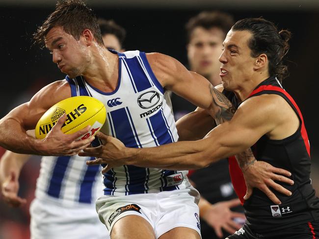 AFL Round 6. Essendon vs North Melbourne at Metricon Stadium, Gold Coast. 11/07/2020.   Jy Simpkin of the Kangaroos tries to break the tackle of Dylan Shiel of the Bombers   . Pic: Michael Klein