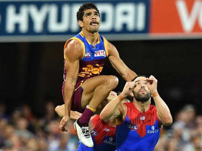 Charlie Cameron soars over Jordan Lewis. Picture: AAP