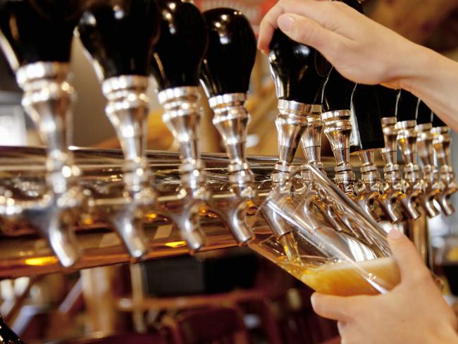 A Female Bartender Pulling a Pint