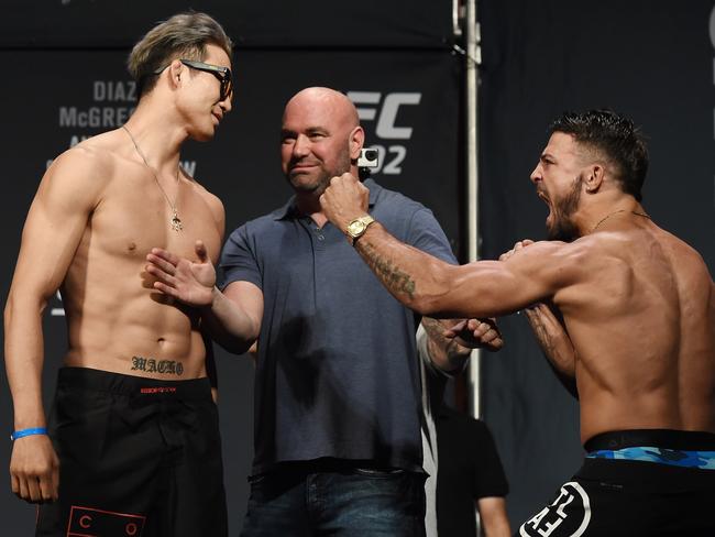 Hyun Gyu Lim (L) smiles as Mike Perry performs a fighting pose.